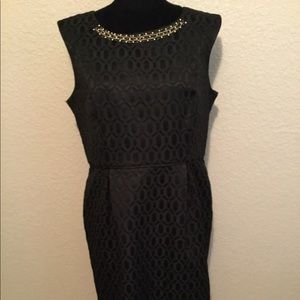 Black and gold beads on the neck of the dress